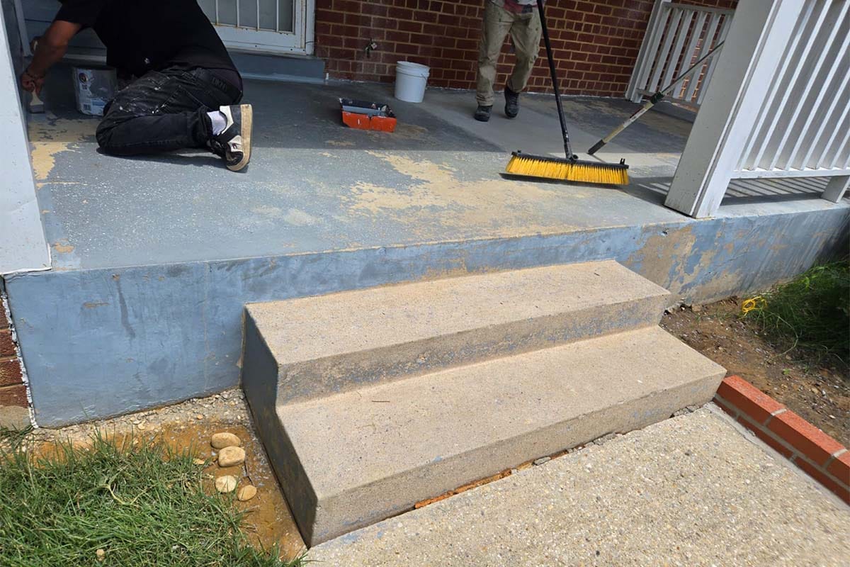 Closeup on damaged concrete steps in the entrance of a DC house