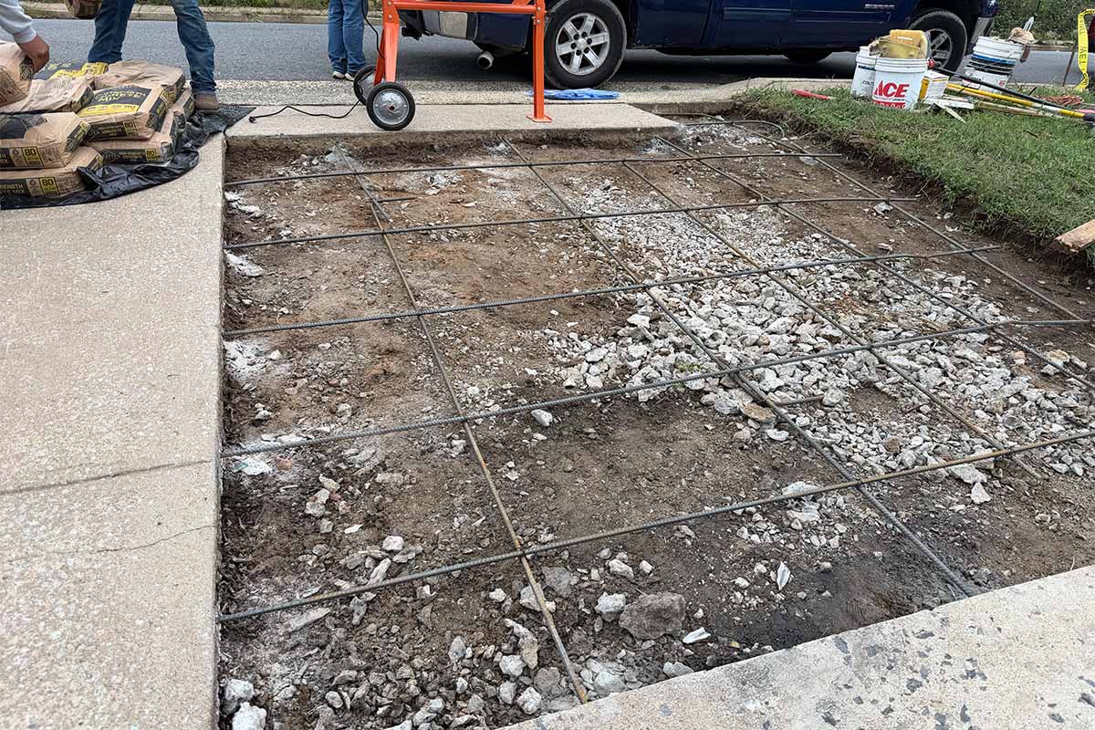 Closeup on driveway repair in progress outside an Arlington home