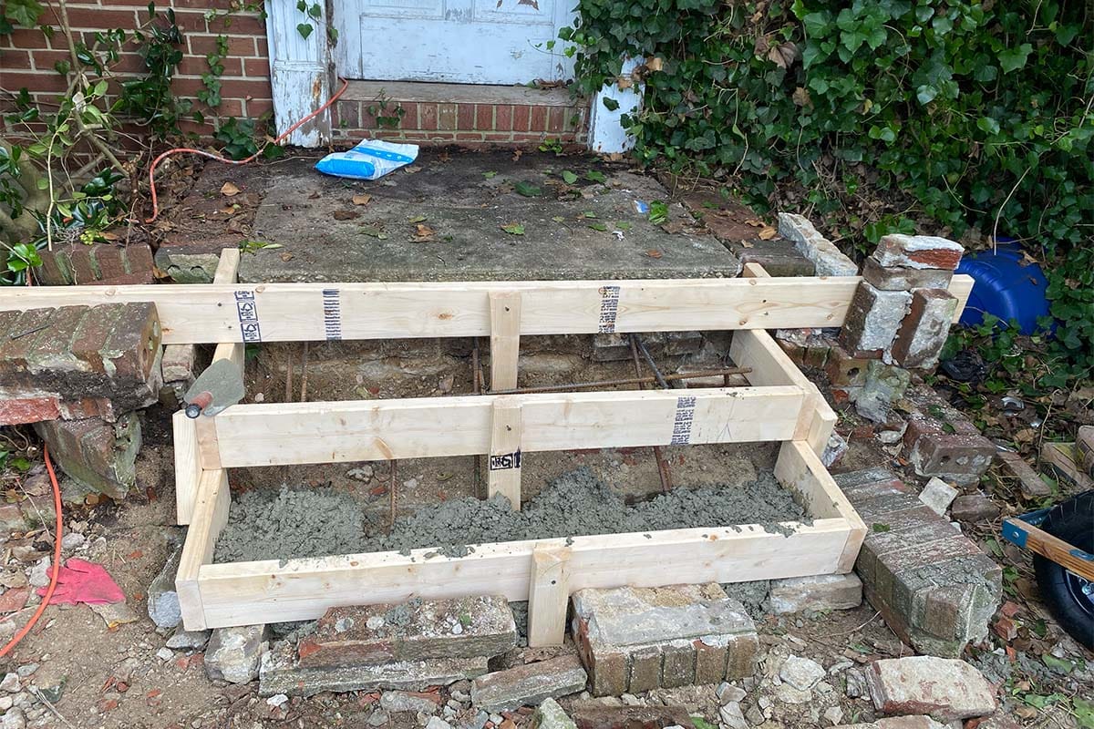 Demolition of old concrete steps in front of a DC house